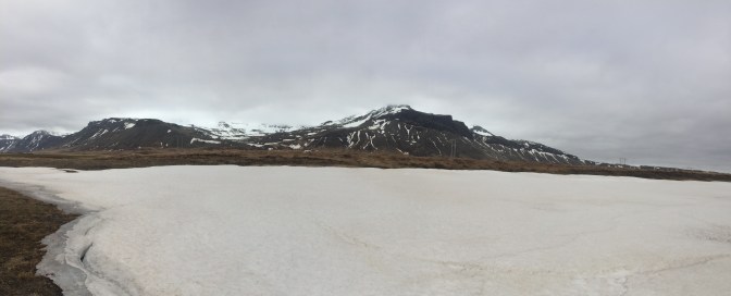 The frozen lake next to a small mountain